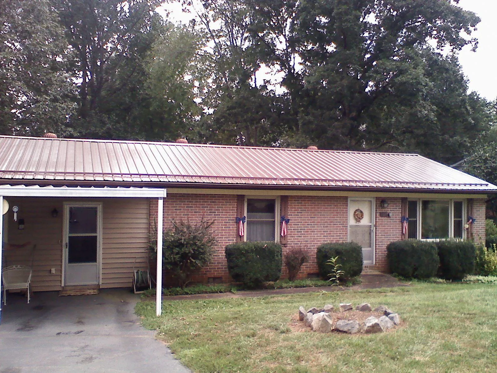 Bronze metal roof and carport on a brick ranch home — Roof Repair work by our crew in Fox River Grove